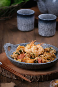 Flatlay angle view of food on table, pangsit tumis serving on stone bowl