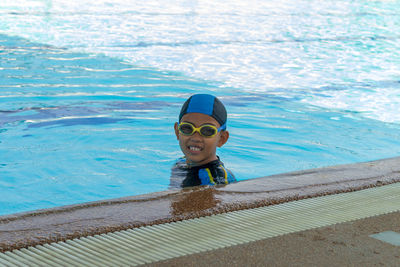 Portrait of boy swimming in pool