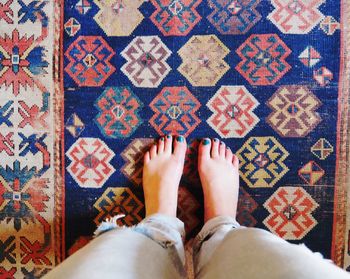 Low section of woman standing on carpet