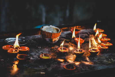 Close-up of burning candles on barbecue