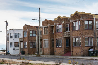 Abandoned buildings in city against sky