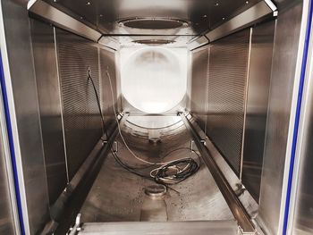 Low angle view of illuminated lighting equipment in factory