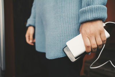 Midsection of man using mobile phone