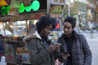 Young women checking their smart phones