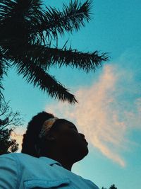Low angle view of man looking away against sky