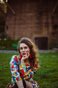 Portrait of young woman sitting outdoors