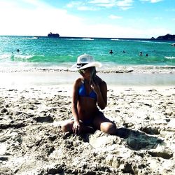 Young woman sitting on beach