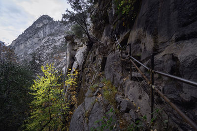 Low angle view of rock formation on land against mountains