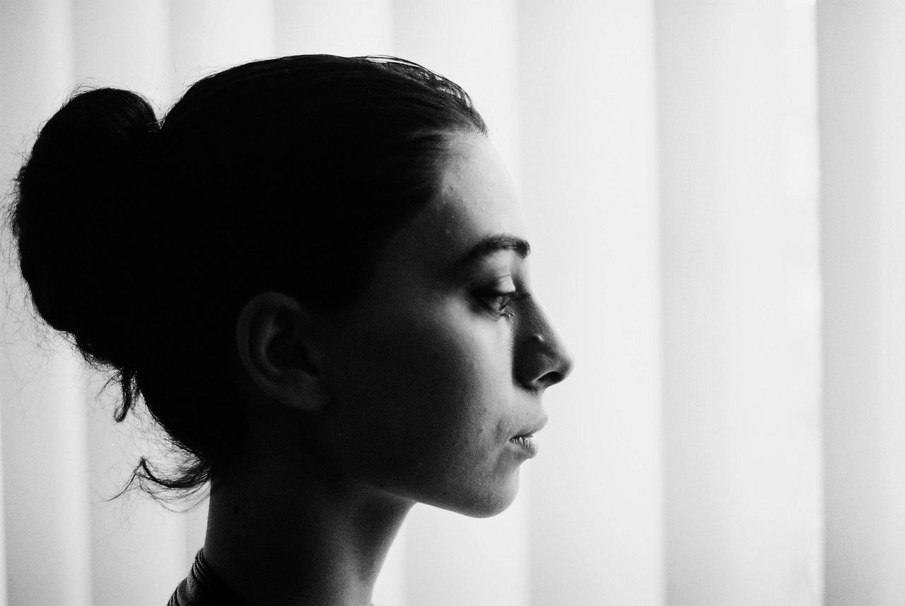 indoors, headshot, close-up, lifestyles, person, human face, contemplation, front view, focus on foreground, young adult, leisure activity, home interior, looking at camera, portrait, head and shoulders, wall - building feature, serious, shirtless