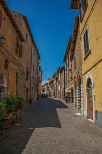 Overview of an alley with old buildings and garage in orvieto, italy.