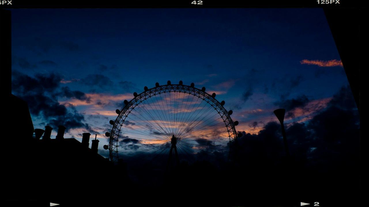 silhouette, sky, low angle view, ferris wheel, built structure, architecture, amusement park, arts culture and entertainment, sunset, cloud - sky, dusk, amusement park ride, building exterior, cloud, tree, circle, illuminated, outdoors, cloudy, city