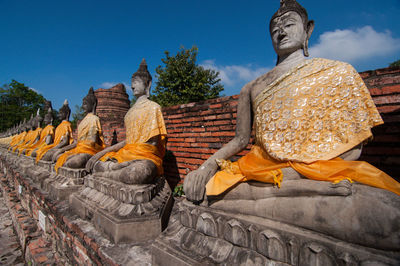 Statue against temple building against sky