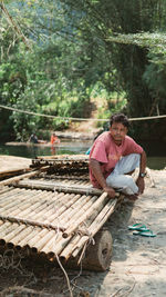 Portrait of man sitting on plant