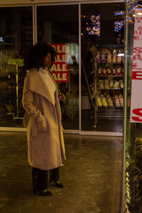 Rear view of woman standing in store