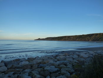 Scenic view of beach against clear sky