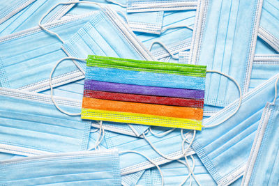 High angle view of multi colored pencils against blue background