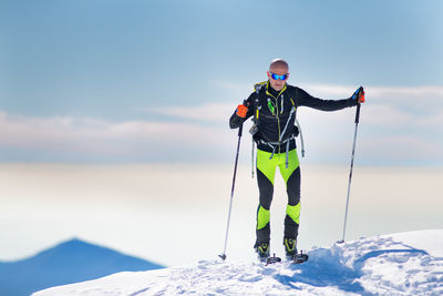 Man standing in snow against mountain range