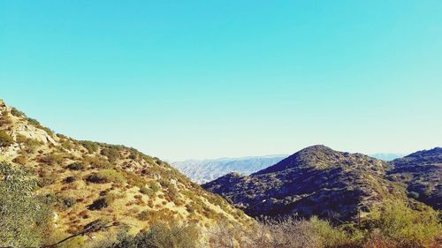 Scenic view of mountains against clear blue sky