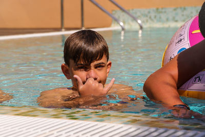 Portrait of boy swimming in pool