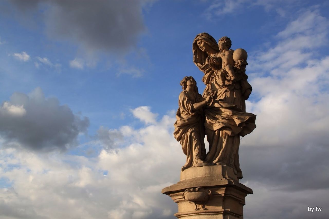 statue, human representation, sculpture, art and craft, art, creativity, low angle view, sky, cloud - sky, cloudy, animal representation, cloud, famous place, carving - craft product, travel destinations, monument, craft, history