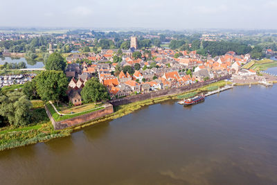 Aerial from the city woudrichem at the river merwede in the netherlands in a flooded landscape