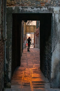 Rear view of woman photographer amidst buildings