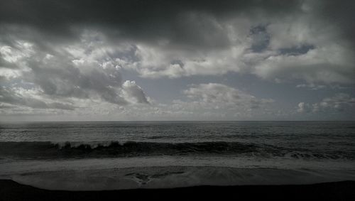 Scenic view of sea against cloudy sky