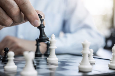 Close-up of man playing with chess