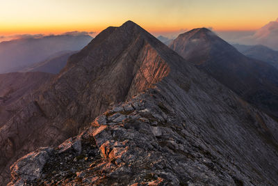 Scenic view of rocky mountains against sky during sunset