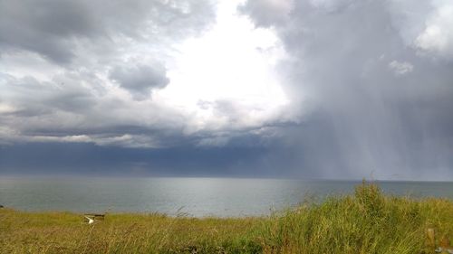 Scenic view of sea against cloudy sky