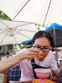 Man eating food on table in restaurant