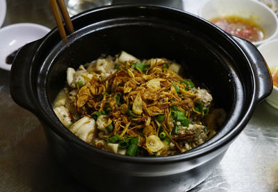 Steamed pig brains topped with veggies and dried onions