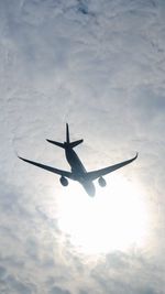 Low angle view of airplane flying in sky