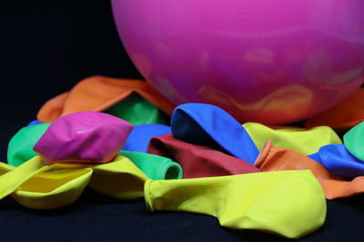 Close-up of multi colored balloons against black background