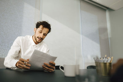 Man reading documents in office