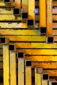 Close-up of yellow rusty metal arranged outdoors