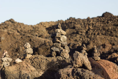 Close-up of stacked rocks against sky