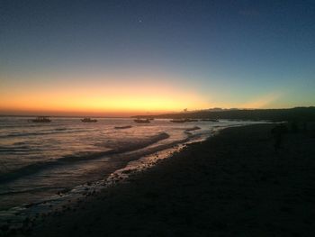 Scenic view of sea against clear sky during sunset