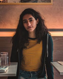 Portrait of teenage girl sitting in restaurant