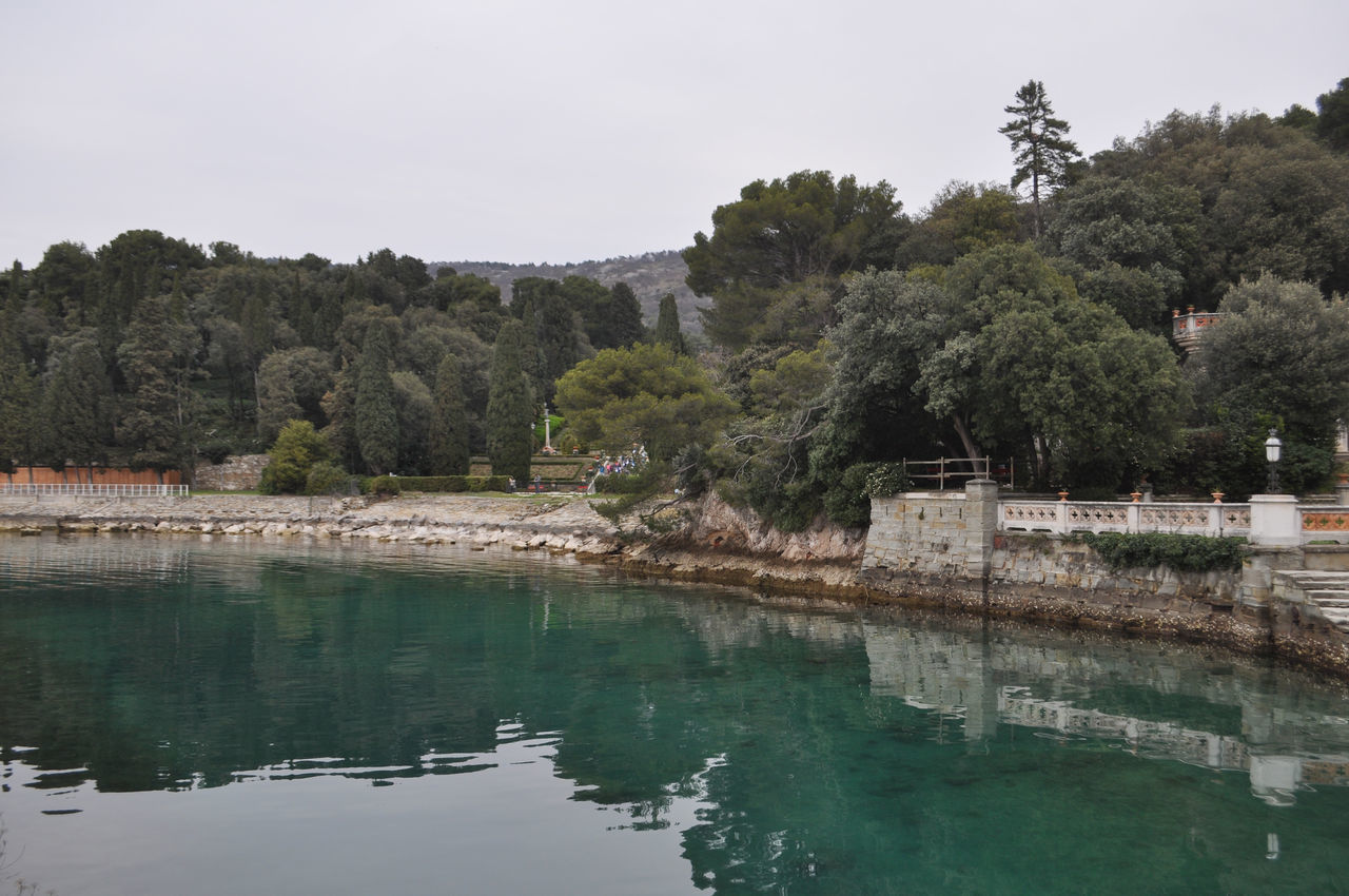 water, tree, plant, river, nature, reservoir, reflection, sky, environment, travel destinations, land, scenics - nature, architecture, beauty in nature, no people, tourism, landscape, tranquility, travel, body of water, outdoors, tranquil scene, beach, pinaceae, coniferous tree, tree area, forest, day, built structure, mountain, non-urban scene, pond, waterway, building