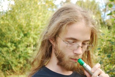 Close-up of man holding electronic cigarette