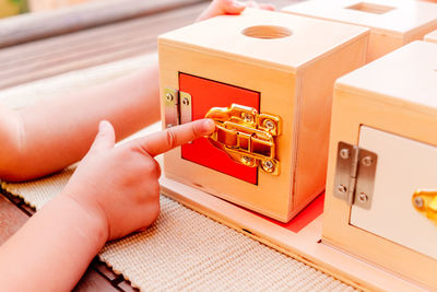 Cropped hands of woman using sewing machine