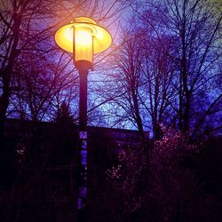 Low angle view of lamp post at night