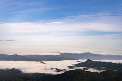 Scenic view of cloudscape over mountains against sky