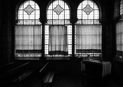 Bench and table by windows in church