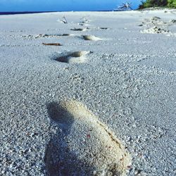 Close-up of pebbles on beach against sky