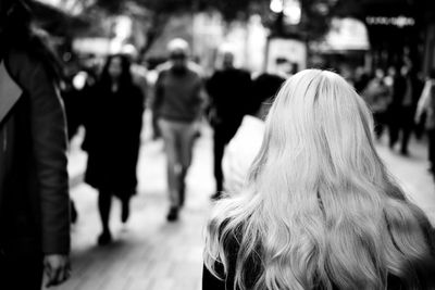 Rear view of people walking outdoors