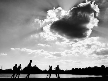 Silhouette of people at sunset