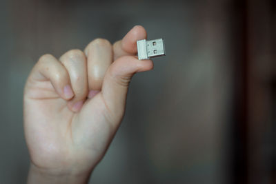 Close-up of person hand holding computer equipment at home