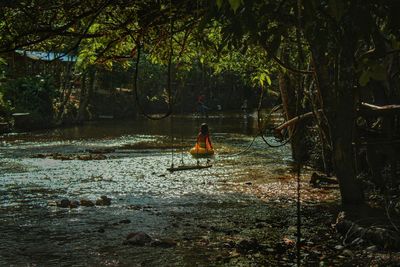 Kid playing in natural river